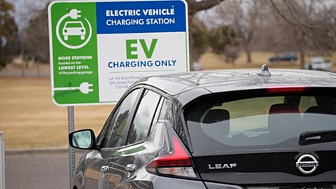 A Nissan Leaf charges at a recharge station outside the Denver Museum of Nature and Science Friday, Dec. 24, 2021, in Denver. (AP Photo/David Zalubowski)