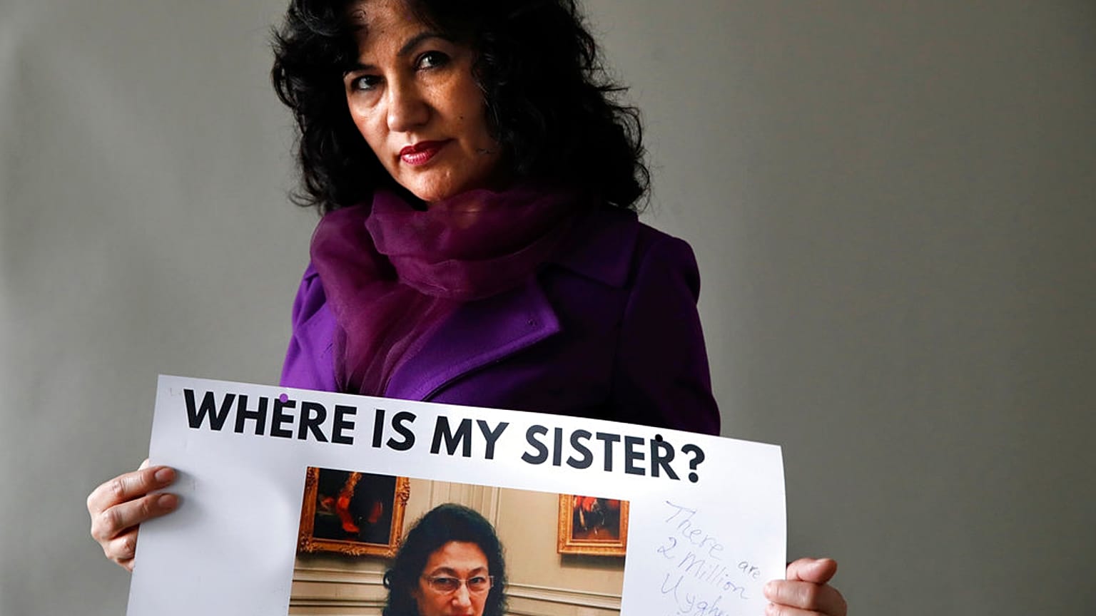 Rushan Abbas, 51, of Herndon, Va., holds a photo of her sister, Gulshan Abbas.