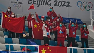 Chinese fans cheer after a China win against Australia during the mixed doubles curling match at the Beijing Winter Olympics Thursday, Feb. 3, 2022, in Beijing. 