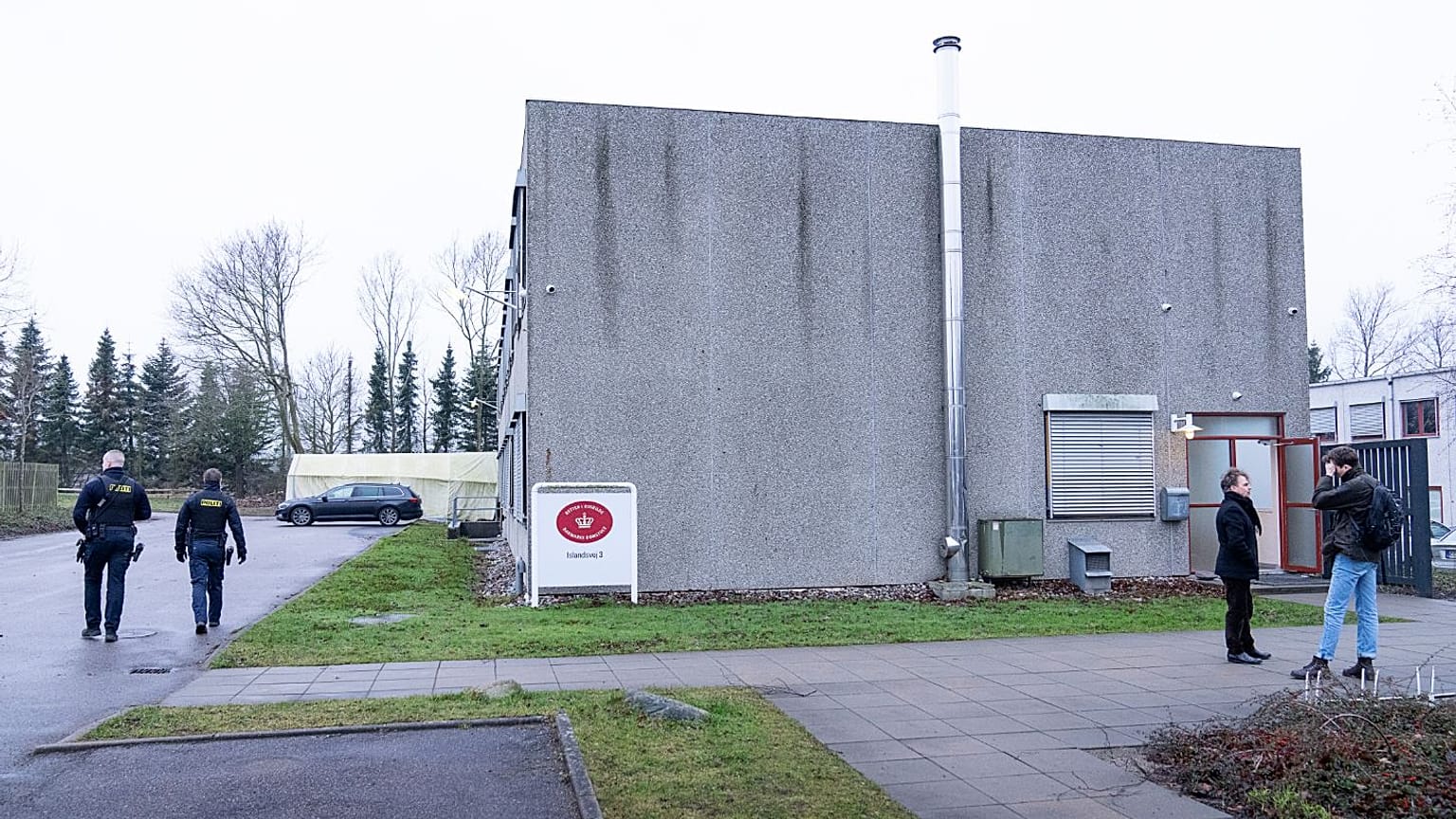 Armed Police officers patrol outside the specially builty courtroom in Roskildes.