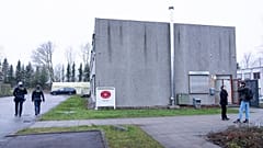 Armed Police officers patrol outside the specially builty courtroom in Roskildes.