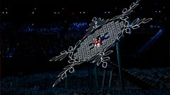China's athletes Dinigeer Yilamujian and Zhao Jiawen prepare to light the cauldron during the opening ceremony of the 2022 Winter Olympics