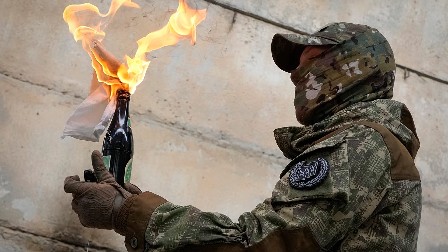 A local resident prepares a Molotov cocktail during an all-Ukrainian training campaign "Don't panic! Get ready!" close to Kyiv, Ukraine, Sunday, Feb. 6, 2022