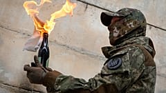 A local resident prepares a Molotov cocktail during an all-Ukrainian training campaign "Don't panic! Get ready!" close to Kyiv, Ukraine, Sunday, Feb. 6, 2022