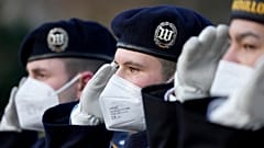 Soldiers of the honor guard wear face masks as they attend a military welcome ceremony by German President Frank-Walter Steinmeier