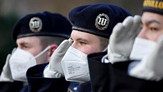 Soldiers of the honor guard wear face masks as they attend a military welcome ceremony by German President Frank-Walter Steinmeier