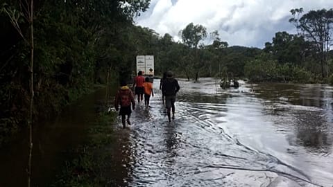 People walking by a flooded road