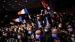 Fans wave French flags as Valerie Pecresse, candidate for the French presidential election 2022, delivers a speech during a meeting in Paris, France on 11 December 2021.