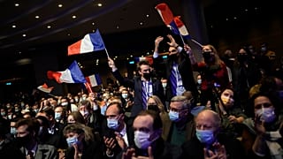 Fans wave French flags as Valerie Pecresse, candidate for the French presidential election 2022, delivers a speech during a meeting in Paris, France on 11 December 2021.