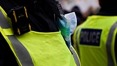 A police officers stands outside Downing Street during an anti-vaccine protest in London.