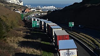 Lorries queue to embark on a ferry at the Port of Dover, southeast England, on January 13, 2022.