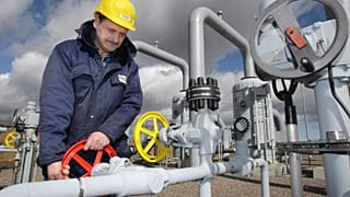 A technician works at a valve in the Natural Gas Compress Station in Sayda, eastern Germany, March 12, 2008.