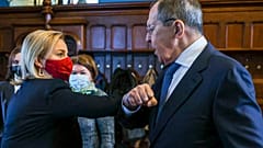In this handout photo released by Russian Foreign Ministry, British and Russian foreign ministers Liz Truss and Sergei Lavrov greet each other in Moscow, Feb. 10, 2022.