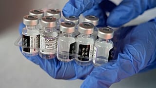 A medical worker shows vials of the Pfizer COVID-19 vaccine near Jakarta, Indonesia.