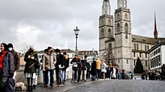 People queue from the Muenster Bridge to vote in a COVID-19 referendum, in Zurich, Switzerland, in this file photograph from Nov. 28, 2021.