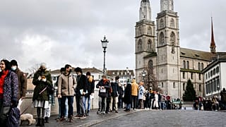 People queue from the Muenster Bridge to vote in a COVID-19 referendum, in Zurich, Switzerland, in this file photograph from Nov. 28, 2021.