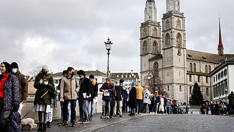 People queue from the Muenster Bridge to vote in a COVID-19 referendum, in Zurich, Switzerland, in this file photograph from Nov. 28, 2021.