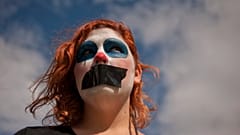 A gagged gay activist from the platform "We are not crime" looks on as she protests against the public security law "Ley Mordaza"