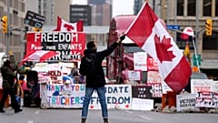 Un manifestante agita una bandera en una protesta contra las medidas del COVID-19 que se ha convertido en una protesta más amplia contra el Gobierno, Ontario, el 11 febrero.