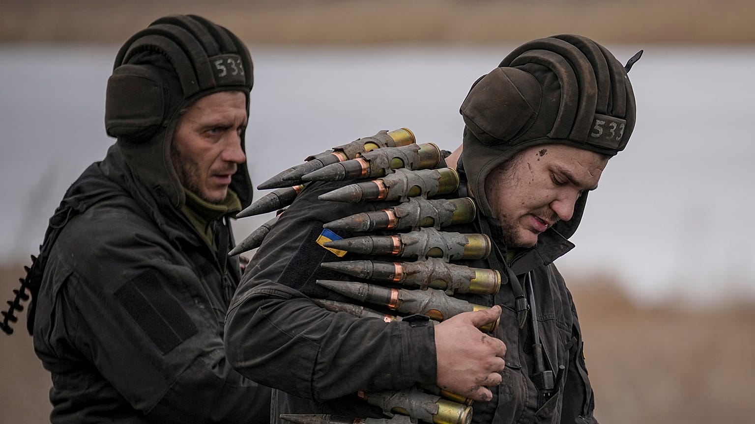 A Ukrainian serviceman carries large caliber ammunitions for armoured vehicles mounted weapons during an exercise in a Joint Forces Operation controlled area in Donbas