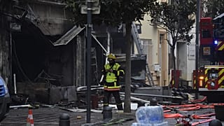 Rescue teams walks near to debris and burned houses after an explosion in Saint-Laurent-de-la-Salanque