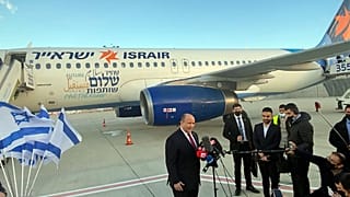Israeli Prime Minister Naftali Bennett speaks to reporters on the tarmac at Ben Gurion Airport before departing for an official visit to Bahrain, in Lod, Israel.