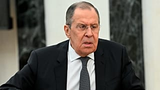 Russian Foreign Minister Sergei Lavrov speaks to Russian President Vladimir Putin during their meeting in Moscow, Russia, Monday, Feb. 14, 2022.
