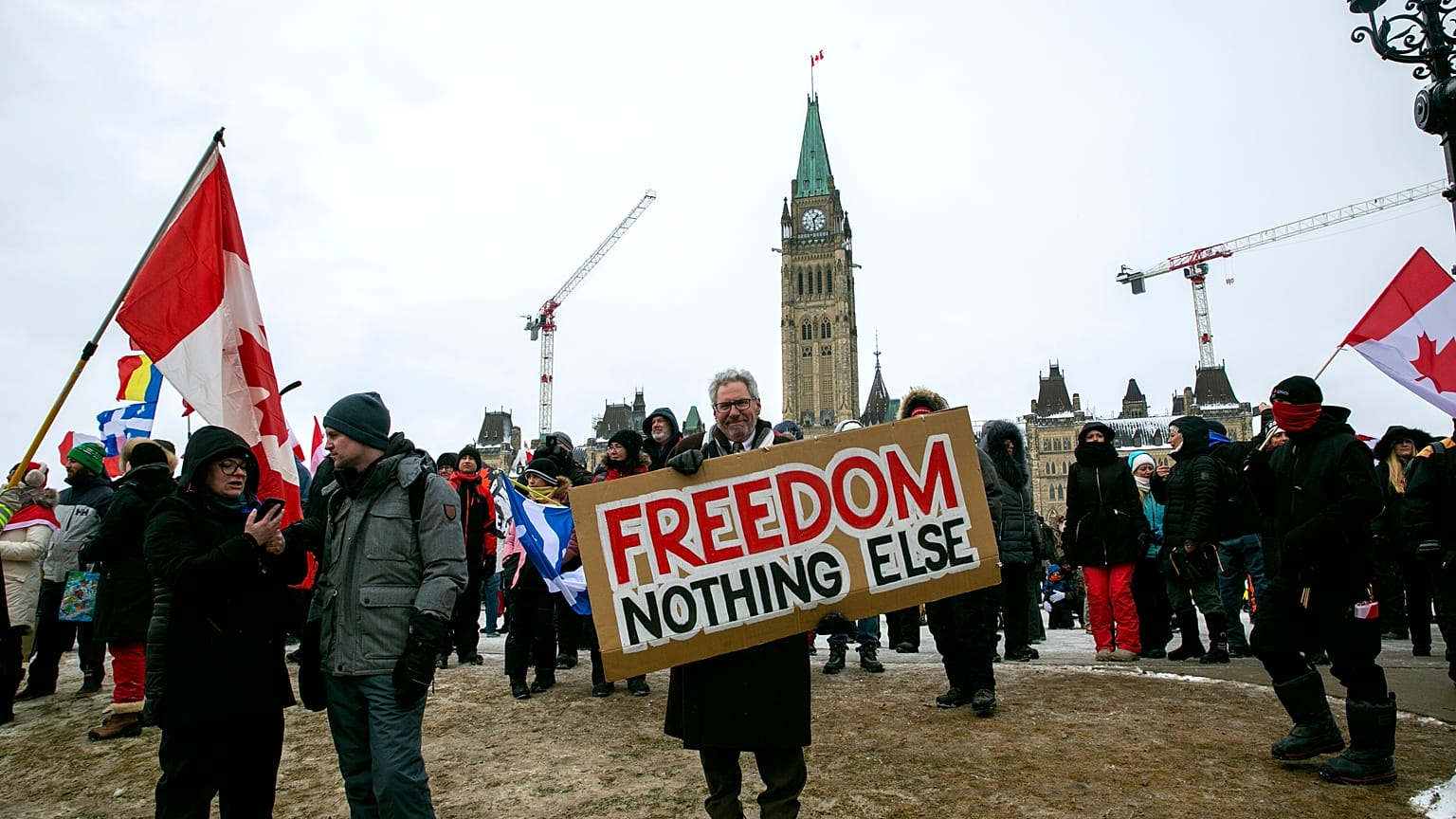 Don Stephens, 65, a retired graphic designer, holds a sign on Parliament Hill to support trucks lined up in protest of COVID-19 vaccine mandates and restrictions in Ottawa.
