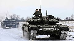 In this photo provided by the Russian Defense Ministry Press Service on Feb. 14, 2022, Russian tanks roll on the field during a military drills in Leningrad region, Russia.
