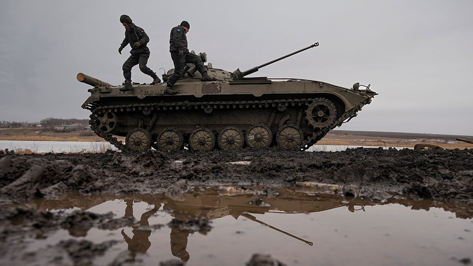 Ukrainian servicemen walk on an armored fighting vehicle during an exercise in a Joint Forces Operation controlled area in the Donetsk region, eastern Ukraine.