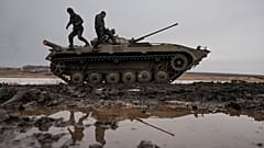 Ukrainian servicemen walk on an armored fighting vehicle during an exercise in a Joint Forces Operation controlled area in the Donetsk region, eastern Ukraine.