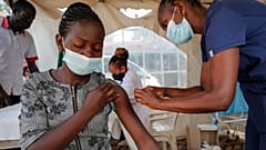 A nurse administers an AstraZeneca vaccine against COVID-19 at a district health centre in the low-income Kibera neighbourhood of Nairobi, Kenya, Jan. 20, 2022.