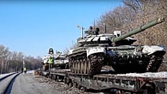 In this photo taken from video provided by the Russian Defense Ministry on Wednesday, 16 February, Russian army tanks are loaded onto railway platforms.