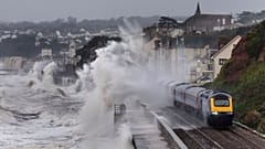 A train is battered by storm waves in Devon, England.