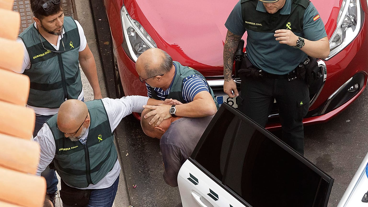 Members of the Spain's Civil Guard lead the suspect away after his arrest in April 2019.
