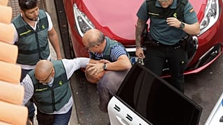 Members of the Spain's Civil Guard lead the suspect away after his arrest in April 2019.