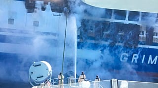 Firefighters hoses down the burning Euroferry Olympia with 291 people on board near the Greek island of Corfu, Friday, Feb. 18, 2022.