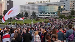People with old Belarusian national flags gather during an opposition rally in Minsk in September 2020.
