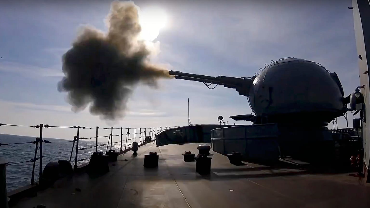 on Friday, Feb. 18, 2022, A cannon mounted on a Russian warship fires during a naval exercise in the Black Sea. 