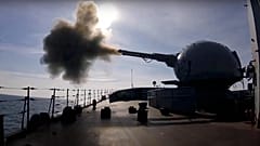 on Friday, Feb. 18, 2022, A cannon mounted on a Russian warship fires during a naval exercise in the Black Sea. 