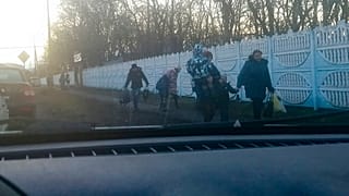 People walk from a bus after evacuating from Donetsk, the territory controlled by pro-Russian militants in eastern Ukraine
