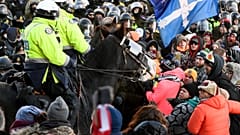 Police take action to put an end to a protest, which started over mandatory COVID vaccine mandates and grew into a wider anti-government demonstration, Feb. 18, 2022, Ottawa.