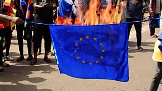 Demonstrators burn EU flag