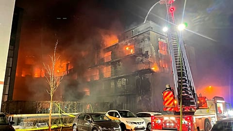 Firefighters battle a fire at residential complex in Essen Germany, Feb. 21, 2022. 