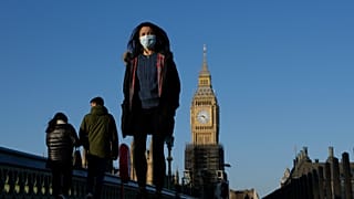 Shoppers walk down Oxford Street, Europe's busiest shopping street, in London, Dec. 23, 2021.