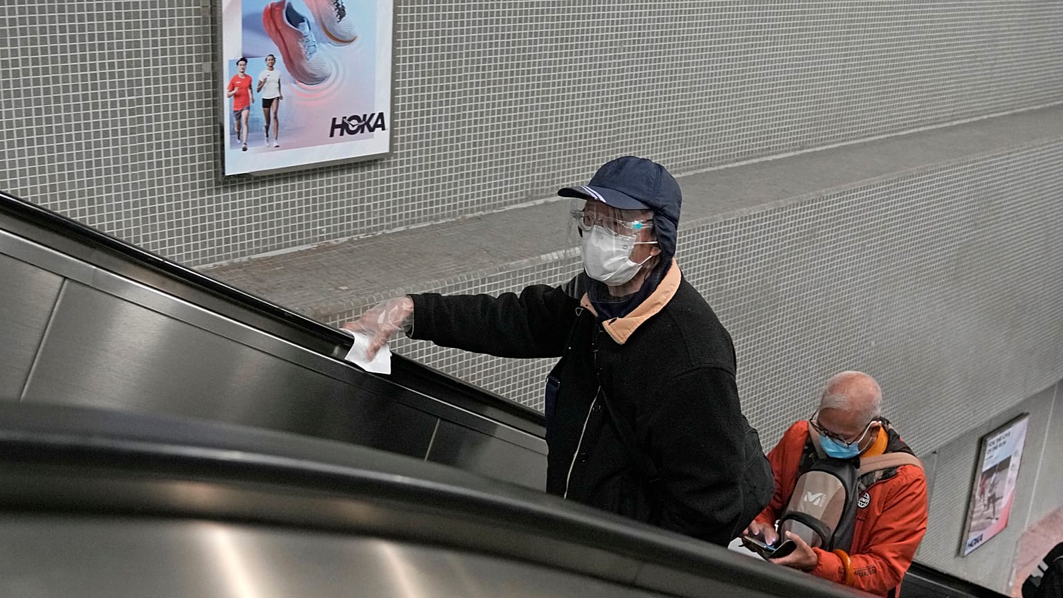 Maszkot viselő utasok a hongkongi metróban