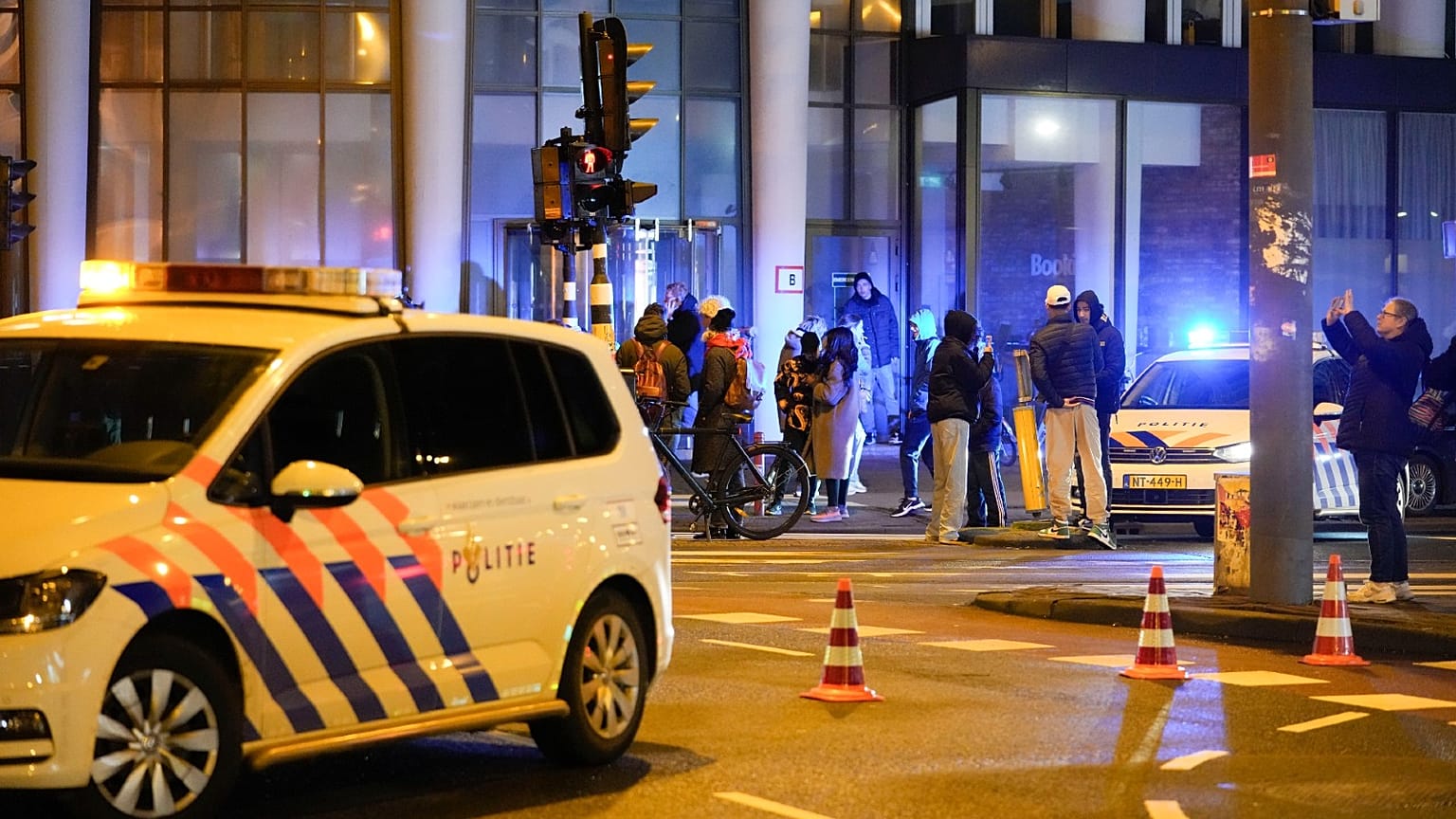 Police vehicles cordon off a wide area in Amsterdam, Netherlands, Feb. 22, 2022, where an armed person is holed up in the Amsterdam Apple Store