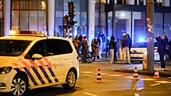 Police vehicles cordon off a wide area in Amsterdam, Netherlands, Feb. 22, 2022, where an armed person is holed up in the Amsterdam Apple Store