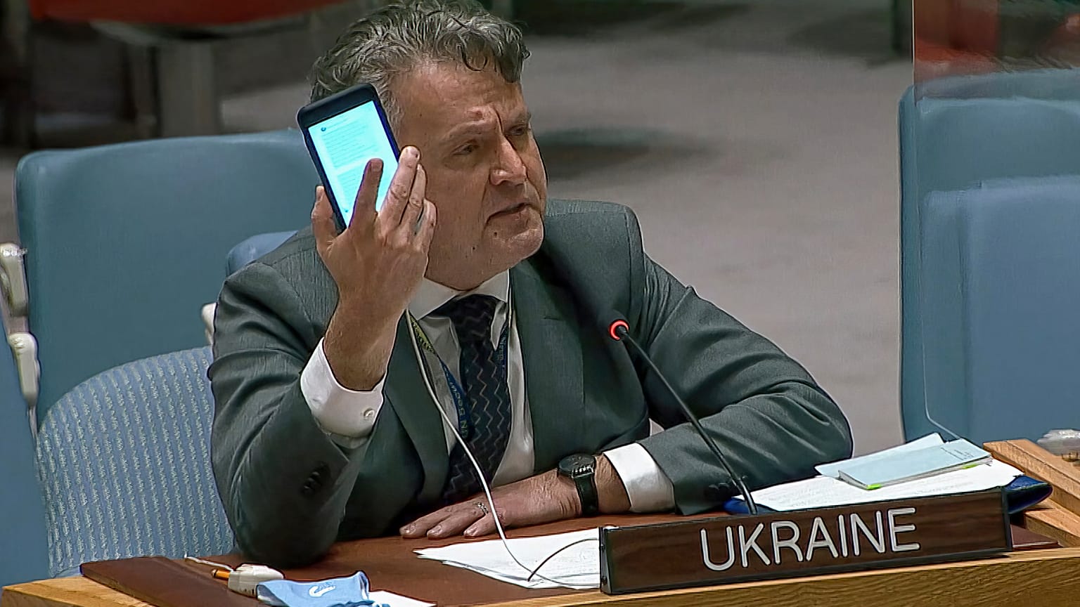 kraine's Ambassador to the United Nations Sergiy Kyslytsya, holds up a phone as he speaks an emergency meeting of the U.N. Security Council Wednesday, Feb. 23, 2022, at the UN
