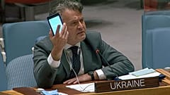 kraine's Ambassador to the United Nations Sergiy Kyslytsya, holds up a phone as he speaks an emergency meeting of the U.N. Security Council Wednesday, Feb. 23, 2022, at the UN